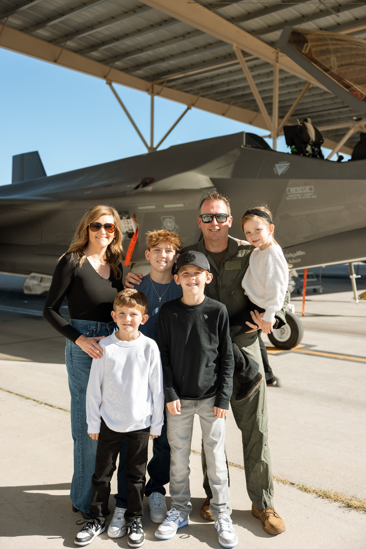 Michael Conrad with his family in front of an F-35 fighter jet